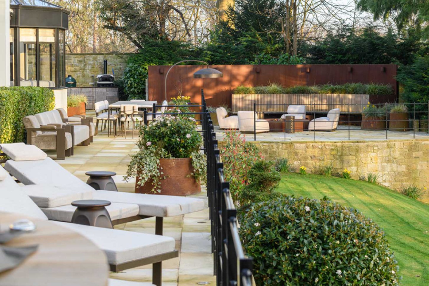 A large sun terrace with a bespoke fire and an outdoor kitchen